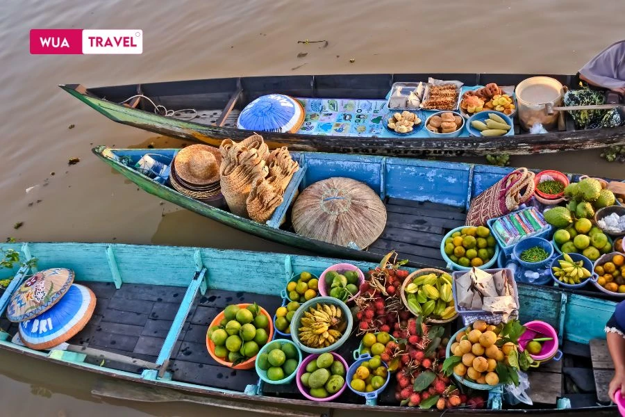 Enjoying fruits at floating market - fresh tropical fruits on Mekong delta waterways