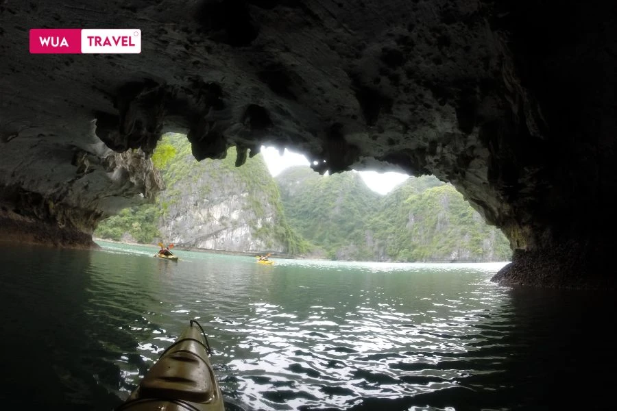 Kayaking through Hang Luon – silent waters and towering limestone cliffs.